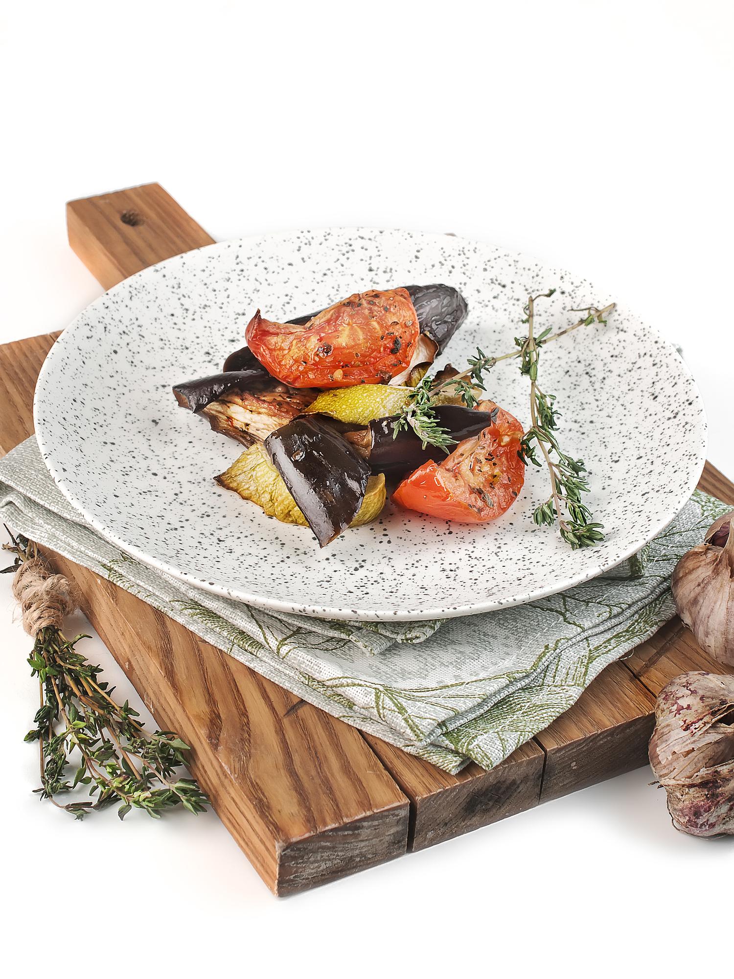 A kitchen counter with crafted plated dish and tools